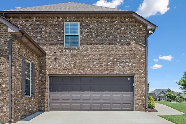 2426 Telford Ln, Murfreesboro, TN 37128 - view of side of home featuring driveway, brick siding, roof with shingles, and an attached garage