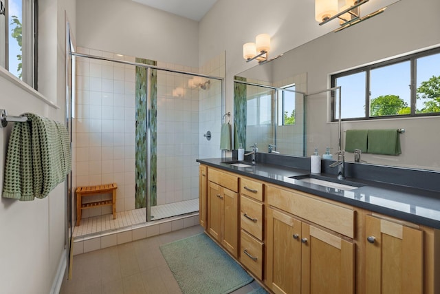 1035 Chester Ave Unit 10, Nashville, TN 37206 - full bath featuring a shower stall, double vanity, a chandelier, and tile patterned flooring
