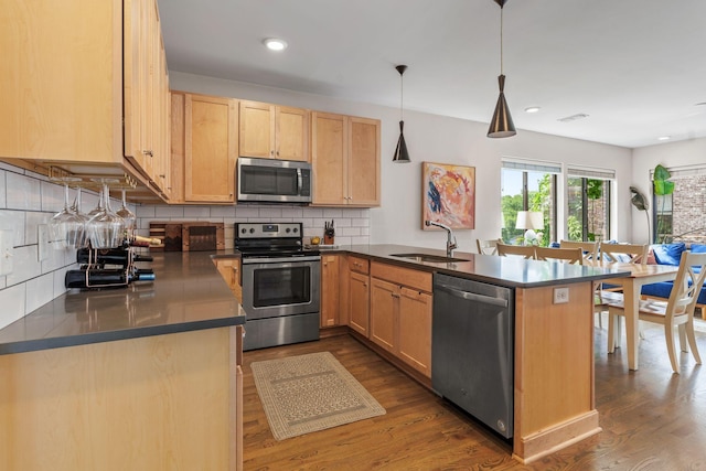 1035 Chester Ave Unit 10, Nashville, TN 37206 - kitchen with appliances with stainless steel finishes, light brown cabinetry, a peninsula, dark wood-type flooring, and recessed lighting