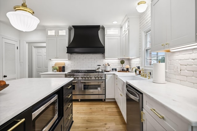 2641 Buckner Rd, Thompsons Station, TN 37179 - kitchen featuring custom exhaust hood, appliances with stainless steel finishes, light countertops, white cabinets, and recessed lighting