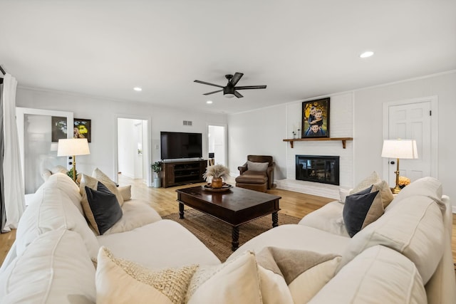 2641 Buckner Rd, Thompsons Station, TN 37179 - living room featuring ceiling fan, a fireplace, light wood-style floors, recessed lighting, and crown molding