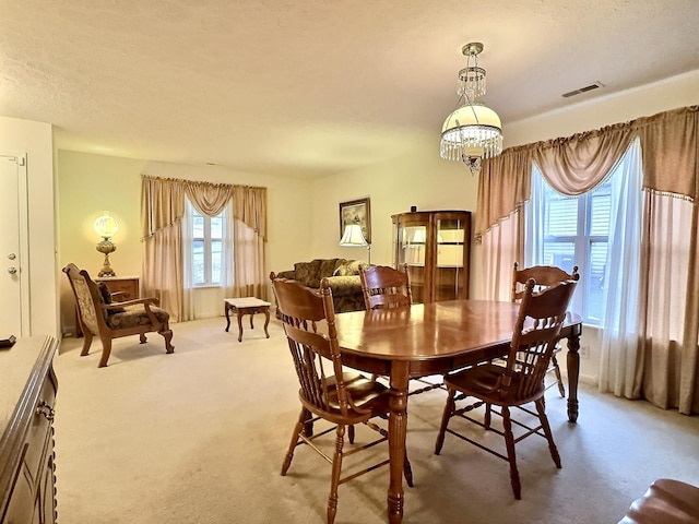 3525 Chandler Cove Way, Antioch, TN 37013 - dining room with light colored carpet, a chandelier, and a textured ceiling