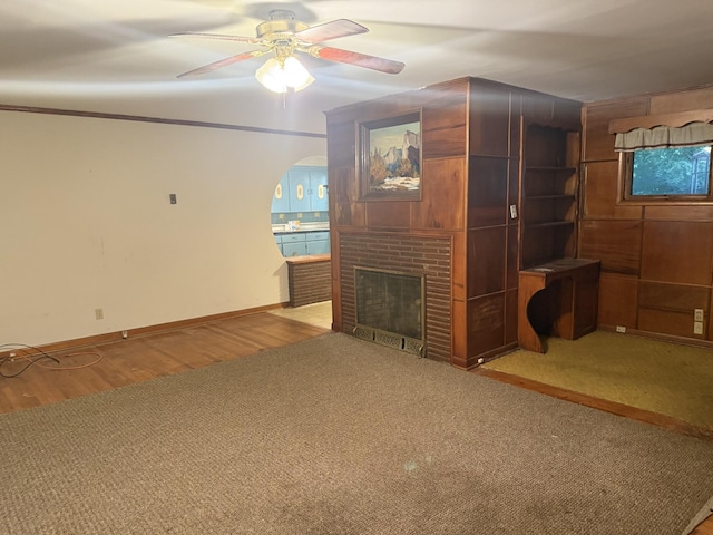 887 Elwood Dr, Clarksville, TN 37040 - unfurnished living room with ceiling fan, a fireplace, carpet, and wood finished floors