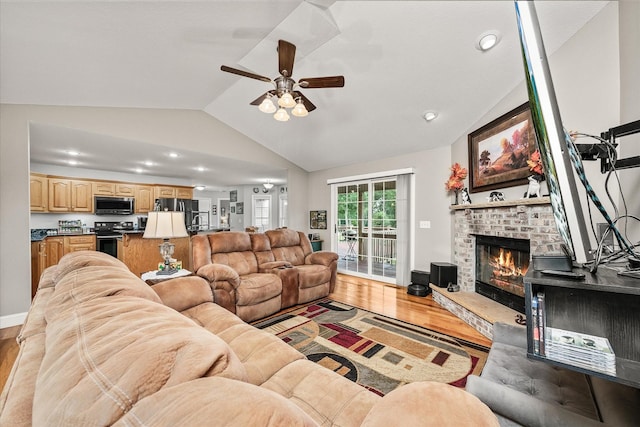 125 Clarence Lee Rd, Lancing, TN 37770 - living room with lofted ceiling, ceiling fan, light wood-type flooring, a brick fireplace, and recessed lighting