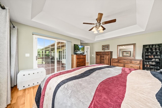 125 Clarence Lee Rd, Lancing, TN 37770 - bedroom with a tray ceiling, access to outside, light wood-style floors, and a ceiling fan