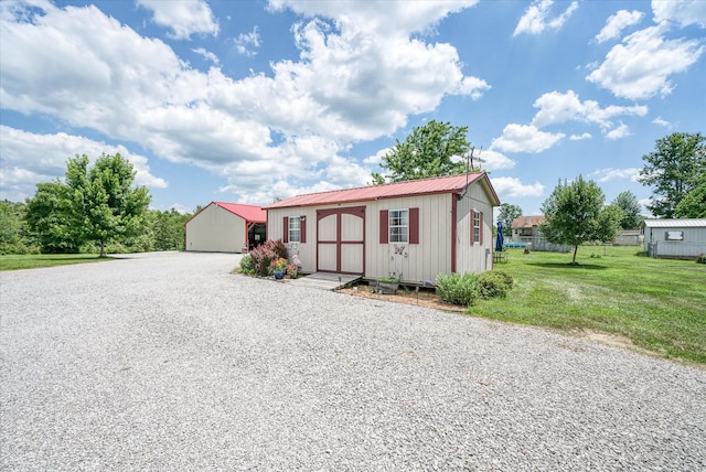 125 Clarence Lee Rd, Lancing, TN 37770 - manufactured / mobile home with an outdoor structure, a front lawn, a metal roof, and driveway