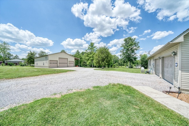 125 Clarence Lee Rd, Lancing, TN 37770 - view of grassy yard with an outbuilding and a detached garage