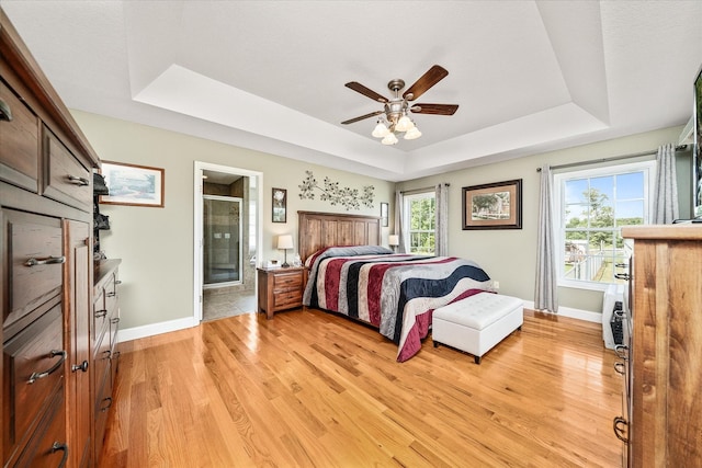 125 Clarence Lee Rd, Lancing, TN 37770 - bedroom with a raised ceiling, light wood finished floors, ensuite bathroom, and a ceiling fan