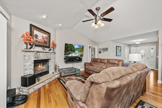 125 Clarence Lee Rd, Lancing, TN 37770 - living area featuring wood finished floors, a ceiling fan, a fireplace, and lofted ceiling