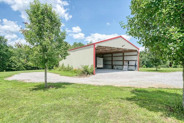 125 Clarence Lee Rd, Lancing, TN 37770 - garage featuring gravel driveway and a carport
