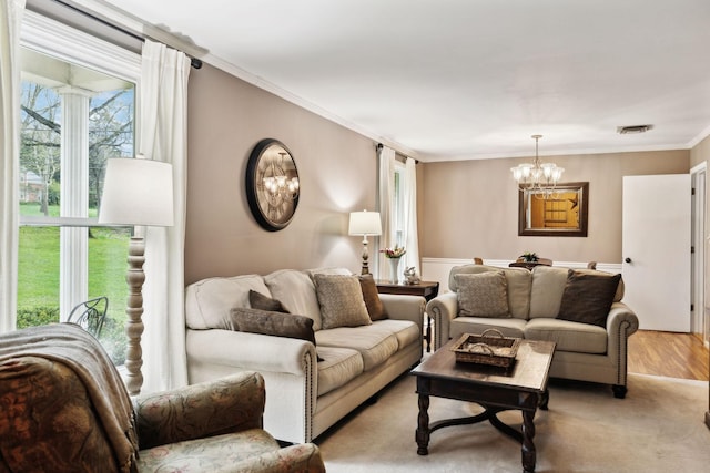 6002 Temple Rd, Nashville, TN 37221 - living room with a chandelier, crown molding, and light wood-style flooring