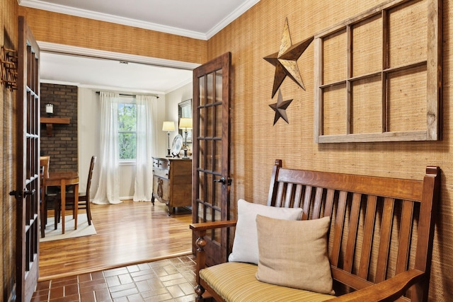 6002 Temple Rd, Nashville, TN 37221 - living area featuring ornamental molding, brick patterned flooring, french doors, and wallpapered walls