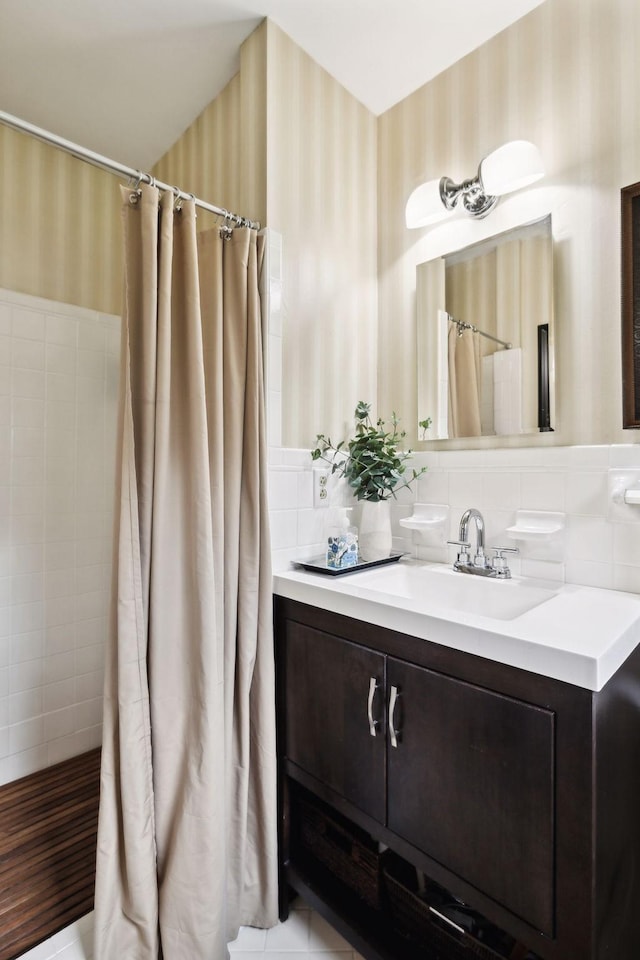 6002 Temple Rd, Nashville, TN 37221 - full bathroom featuring wallpapered walls, tile walls, vanity, curtained shower, and a wainscoted wall