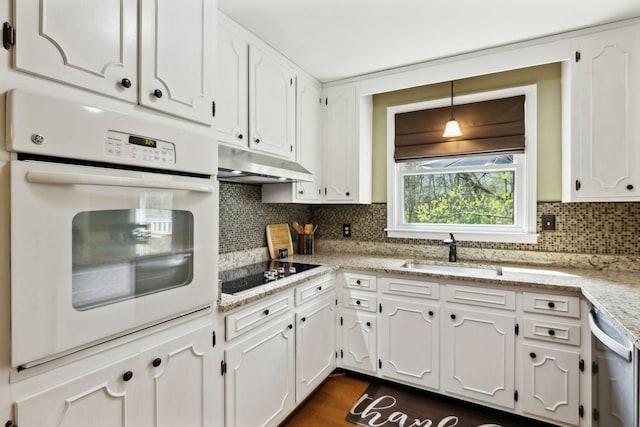 6002 Temple Rd, Nashville, TN 37221 - kitchen with white oven, under cabinet range hood, black electric stovetop, and white cabinets