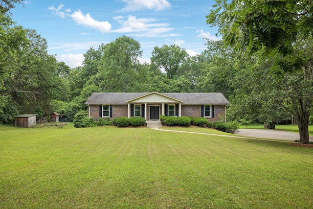 6002 Temple Rd, Nashville, TN 37221 - ranch-style house with a front yard, a storage unit, and brick siding