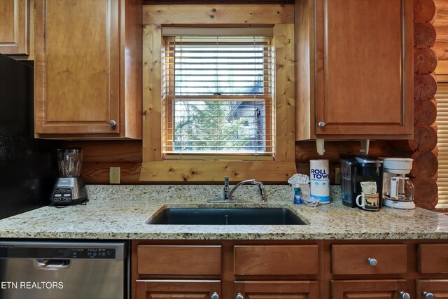 849 Golf View Blvd, Pigeon Forge, TN 37863 - kitchen with dishwasher, rustic walls, light stone countertops, and brown cabinetry