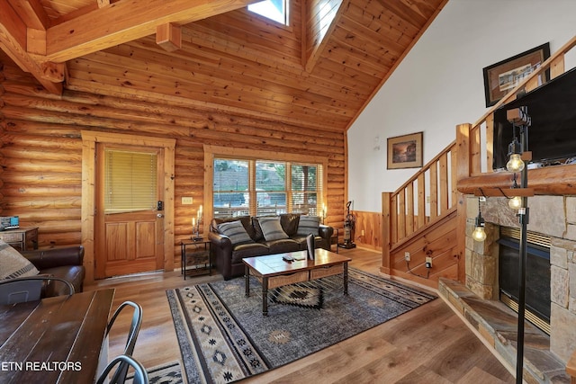 849 Golf View Blvd, Pigeon Forge, TN 37863 - living room featuring high vaulted ceiling, a wooden ceiling with exposed beams, a skylight, stairs, and a stone fireplace