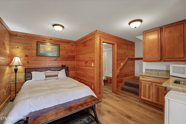 849 Golf View Blvd, Pigeon Forge, TN 37863 - bedroom featuring light wood-style floors and wooden walls