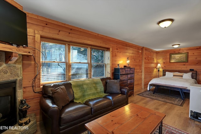 849 Golf View Blvd, Pigeon Forge, TN 37863 - bedroom with a stone fireplace, wooden walls, and wood finished floors