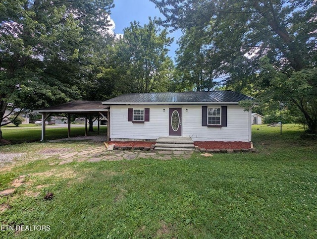 1014 Frank Campbell Rd, Jamestown, TN 38556 - view of front of home featuring a front yard, a metal roof, and an attached carport