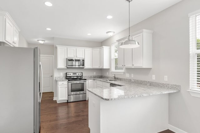 708 Ellie Dr, Madison, TN 37115 - kitchen featuring stainless steel appliances, a peninsula, white cabinets, and recessed lighting