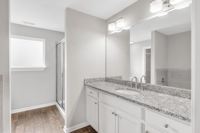 708 Ellie Dr, Madison, TN 37115 - bathroom with wood finished floors, vanity, a stall shower, and a walk in closet