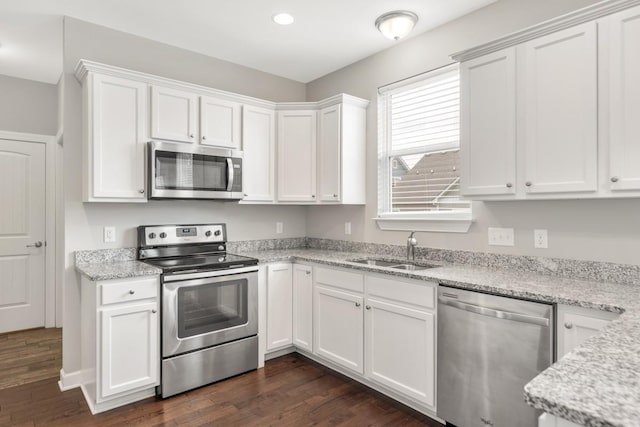708 Ellie Dr, Madison, TN 37115 - kitchen with appliances with stainless steel finishes, dark wood-style floors, white cabinetry, and recessed lighting