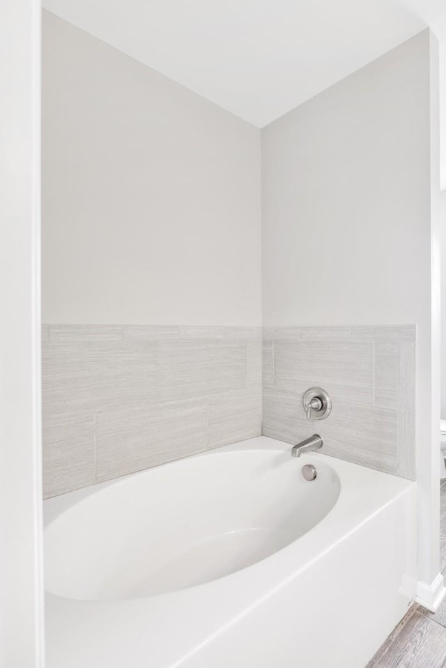 708 Ellie Dr, Madison, TN 37115 - bathroom with a bath and wood finished floors