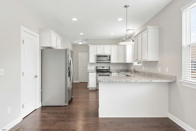 708 Ellie Dr, Madison, TN 37115 - kitchen with appliances with stainless steel finishes, a peninsula, dark wood-style floors, recessed lighting, and white cabinets