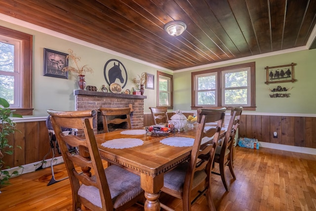 1539 Old Florence Rd, Lawrenceburg, TN 38464 - dining room with ornamental molding, healthy amount of natural light, wainscoting, hardwood / wood-style flooring, and a fireplace