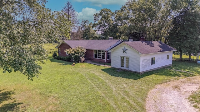 1539 Old Florence Rd, Lawrenceburg, TN 38464 - view of front of property featuring french doors, a front lawn, a chimney, driveway, and view of wooded area