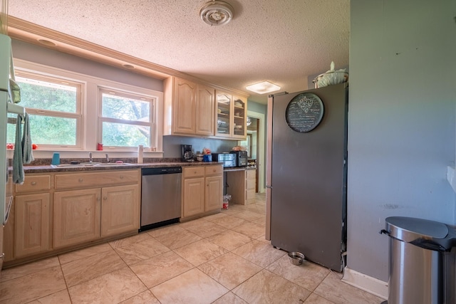 1539 Old Florence Rd, Lawrenceburg, TN 38464 - kitchen featuring stainless steel appliances, a textured ceiling, dark countertops, glass insert cabinets, and light brown cabinets