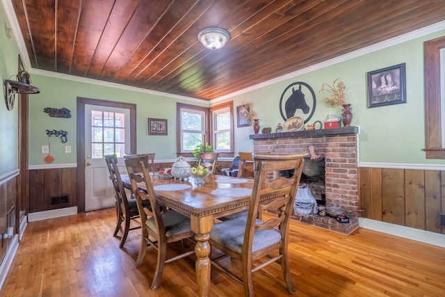 1539 Old Florence Rd, Lawrenceburg, TN 38464 - dining room featuring a wainscoted wall, ornamental molding, wood walls, hardwood / wood-style floors, and wooden ceiling