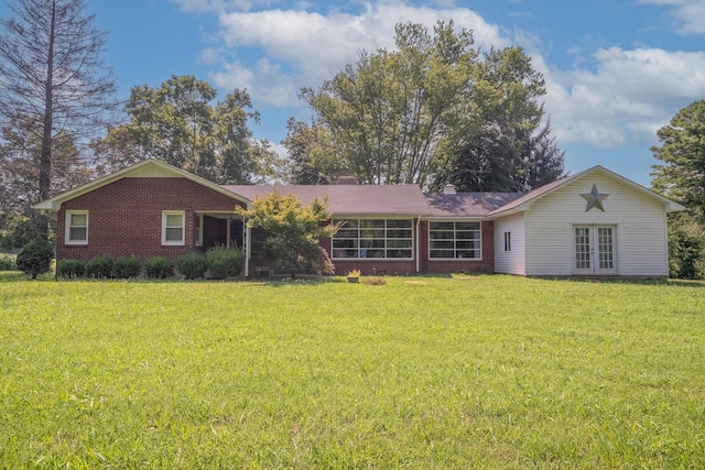 1539 Old Florence Rd, Lawrenceburg, TN 38464 - back of property with brick siding, french doors, a yard, and a chimney