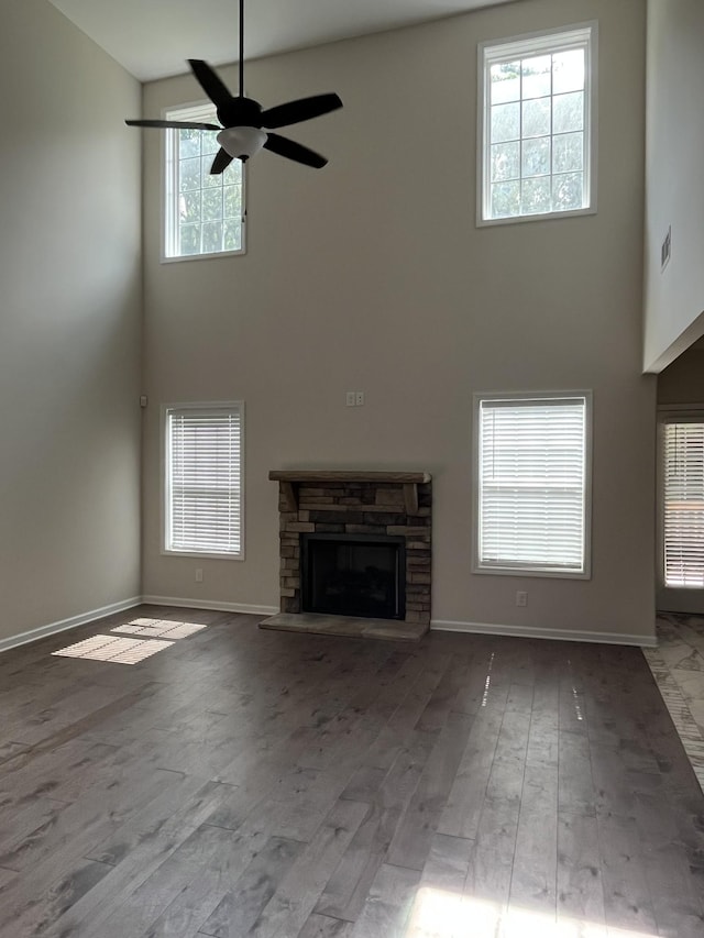 1775 Oak Forest Dr, Clarksville, TN 37043 - unfurnished living room with a towering ceiling, a ceiling fan, a stone fireplace, and wood finished floors