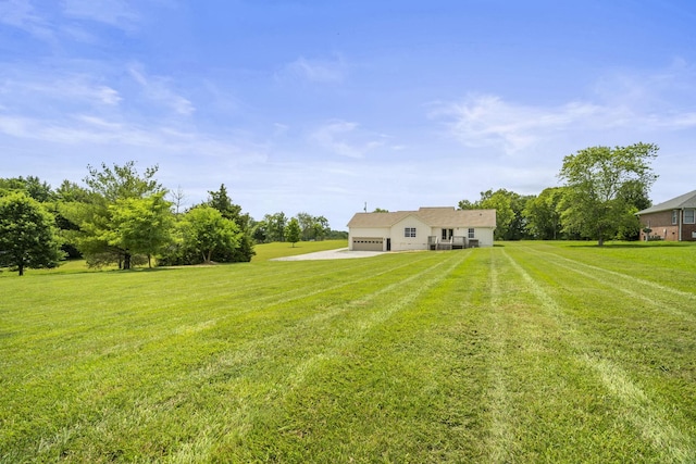 165 Lear Rd, Portland, TN 37148 - view of green lawn with a garage and driveway