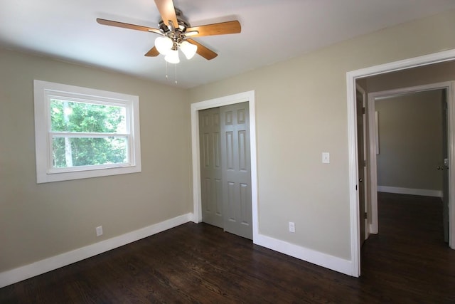 762 Austin Bottom Rd, Baxter, TN 38544 - unfurnished bedroom with a closet, dark wood finished floors, and a ceiling fan