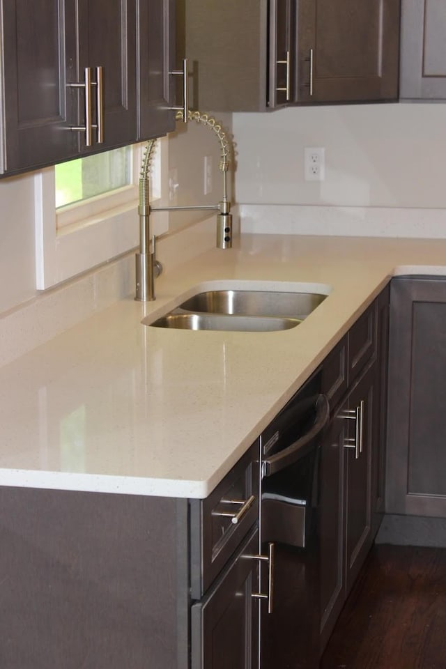 762 Austin Bottom Rd, Baxter, TN 38544 - kitchen with dark brown cabinets, stainless steel dishwasher, dark wood-style flooring, and light stone countertops