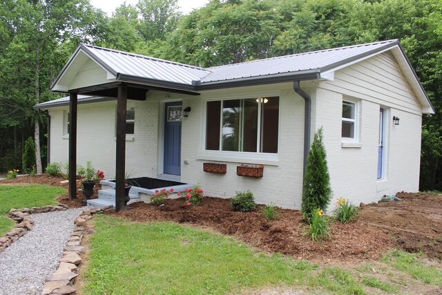 762 Austin Bottom Rd, Baxter, TN 38544 - ranch-style home featuring brick siding and a metal roof