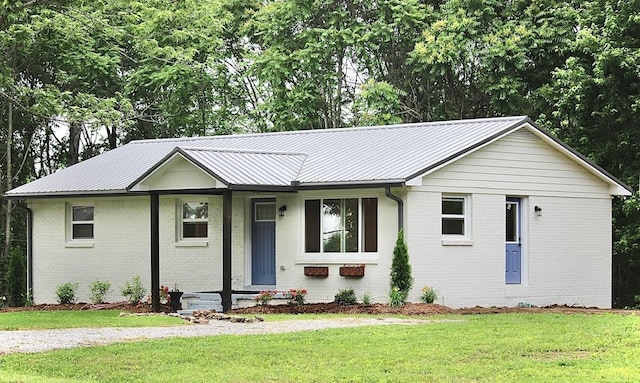 762 Austin Bottom Rd, Baxter, TN 38544 - single story home with a front yard, brick siding, and a metal roof