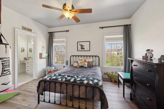 8217 W Chase Ct, Nashville, TN 37221 - bedroom with multiple windows, wood finished floors, ensuite bath, and ceiling fan
