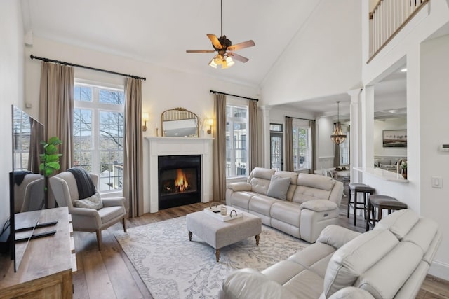 8217 W Chase Ct, Nashville, TN 37221 - living room featuring ceiling fan, wood finished floors, a warm lit fireplace, and high vaulted ceiling