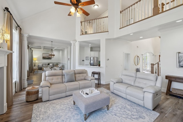 8217 W Chase Ct, Nashville, TN 37221 - living area with ornate columns, a ceiling fan, wood finished floors, high vaulted ceiling, and crown molding