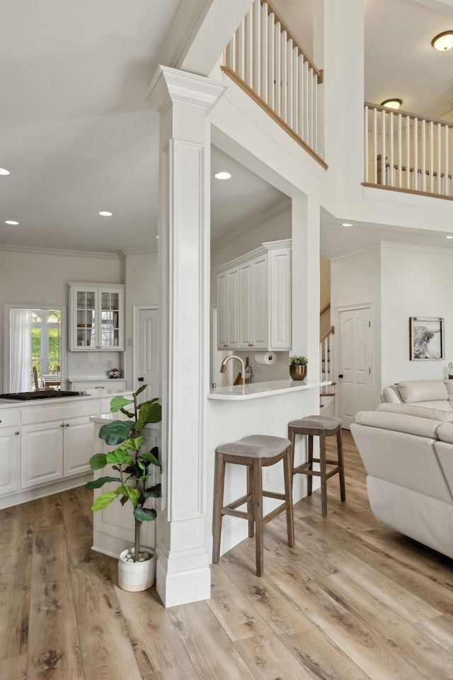 8217 W Chase Ct, Nashville, TN 37221 - living area featuring ornamental molding, light wood finished floors, recessed lighting, a high ceiling, and stairway