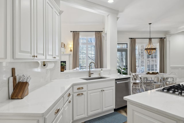 8217 W Chase Ct, Nashville, TN 37221 - kitchen featuring stainless steel appliances, a chandelier, white cabinets, crown molding, and pendant lighting