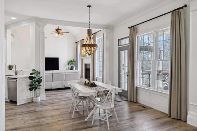 8217 W Chase Ct, Nashville, TN 37221 - dining space featuring healthy amount of natural light, light wood-style floors, crown molding, a chandelier, and a ceiling fan