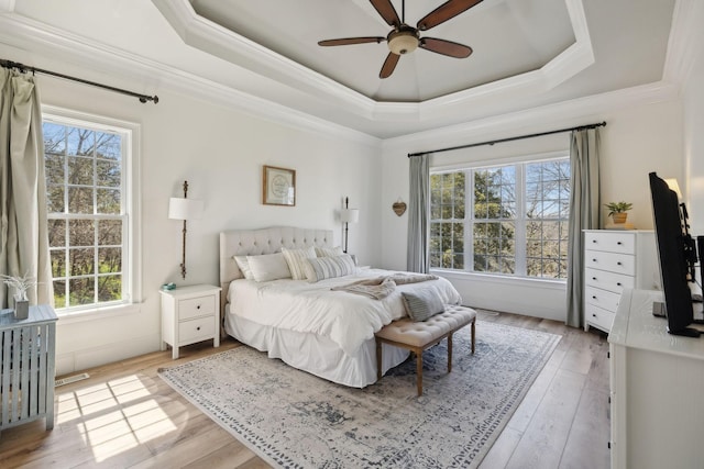 8217 W Chase Ct, Nashville, TN 37221 - bedroom featuring multiple windows, a tray ceiling, light wood-style flooring, and ornamental molding