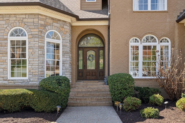 8217 W Chase Ct, Nashville, TN 37221 - entrance to property featuring roof with shingles, stone siding, and brick siding