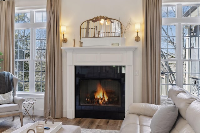 8217 W Chase Ct, Nashville, TN 37221 - living room featuring a lit fireplace and wood finished floors