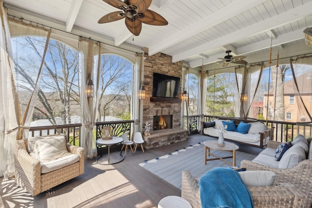 8217 W Chase Ct, Nashville, TN 37221 - sunroom with ceiling fan, an outdoor living space with a fireplace, beamed ceiling, and healthy amount of natural light